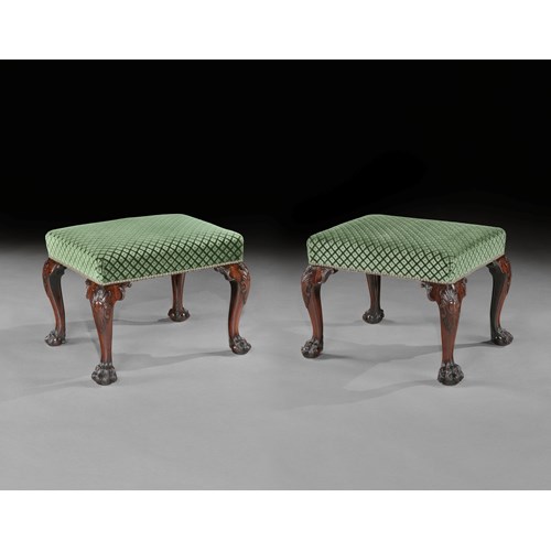 A pair of mahogany stools
